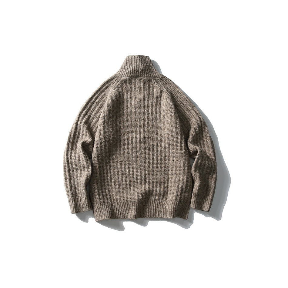 Back view of a taupe rib-knit sweater with a high collar and long sleeves.
