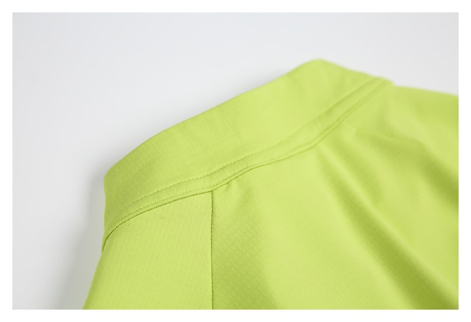 Close-up of the collar and shoulder seams of a bright lime-green garment.
