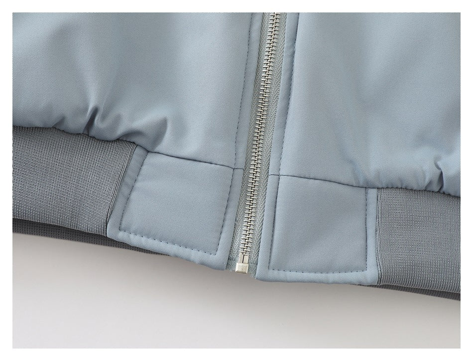 Close-up of the jacket's front zipper and ribbed hem.