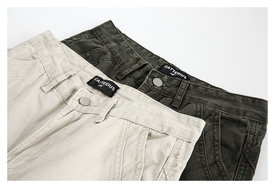 Close-up of light beige and dark charcoal cargo pants showing waistbands, buttons, belt loops, and brand labels.