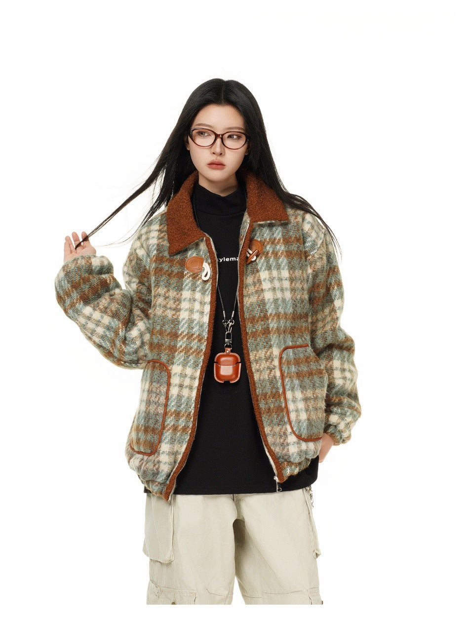 Model wearing an open cream, teal, and rust plaid jacket with a rust collar, front pockets, and toggle closures.