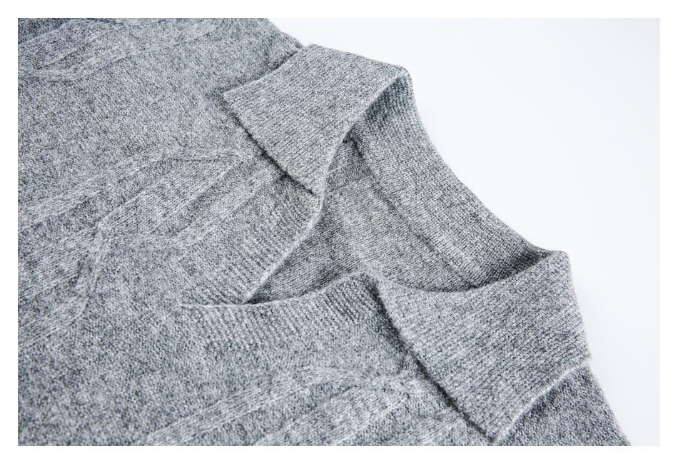 Close-up of a gray knit garment neckline and overlapping collar edge on a white background.