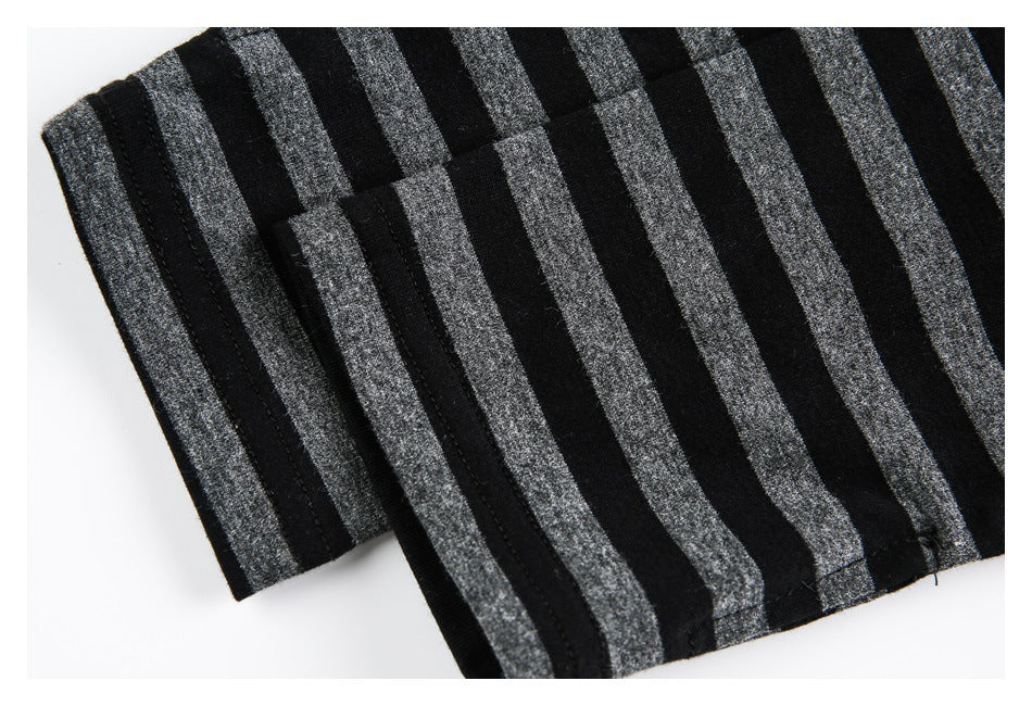 Close-up of black fabric with wide gray vertical stripes and visible stitched edges.