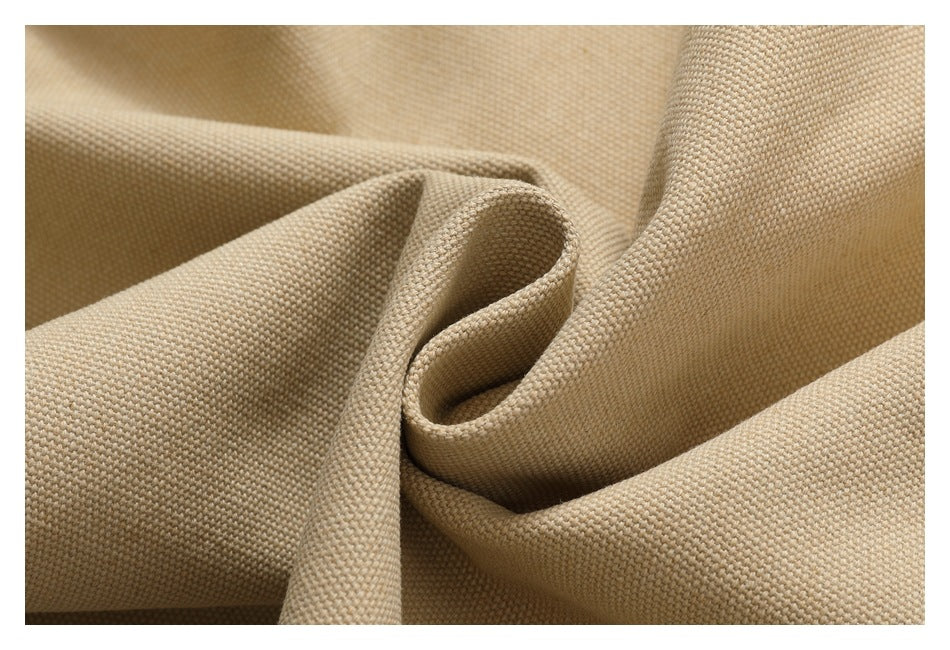 Close-up showing the coarse woven texture and folds of beige garment fabric.