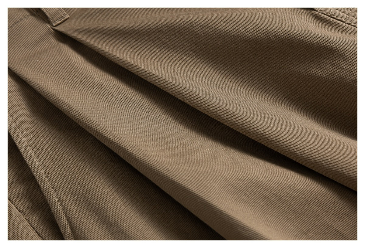 Close-up showing the fine ribbed texture and folds of the taupe shorts fabric.