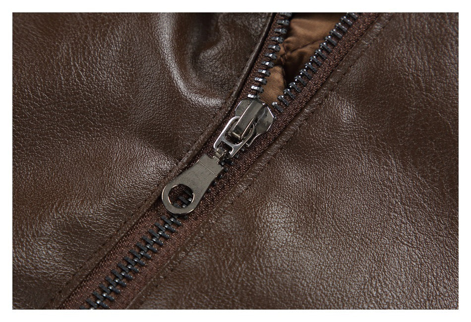Close-up of a dark brown jacket with a diagonal metal zipper and textured surface.