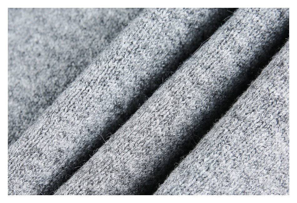 Macro view of the gray marled knit texture, draped in soft folds.