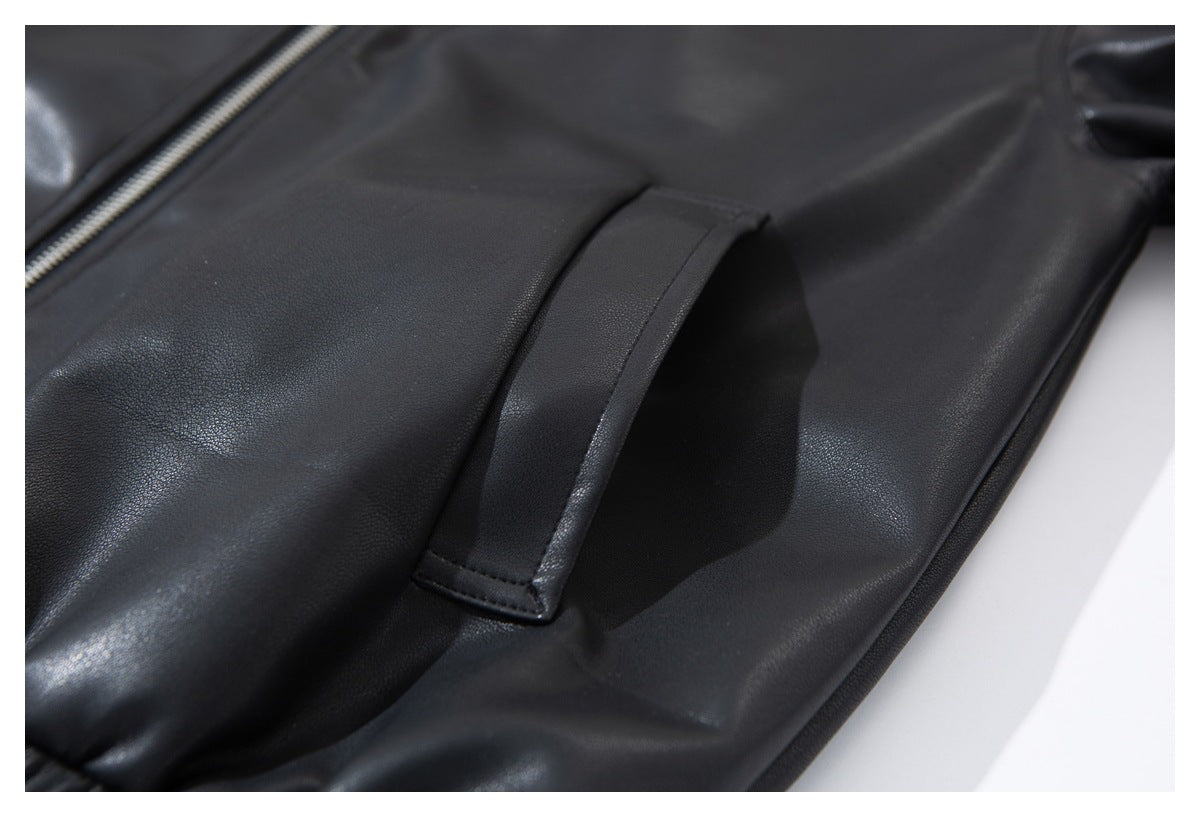 Close-up of a slanted pocket opening on the black jacket.