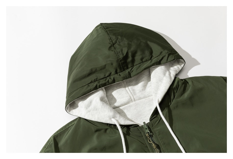 Close-up of a dark olive jacket hood with light gray lining and white drawstrings.