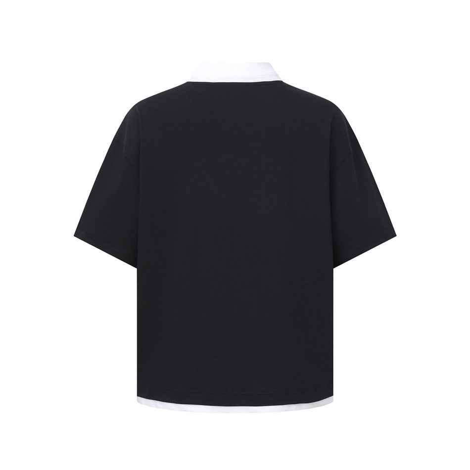 Back view of a black short-sleeve top with a white underlayer visible at the neckline and hem.