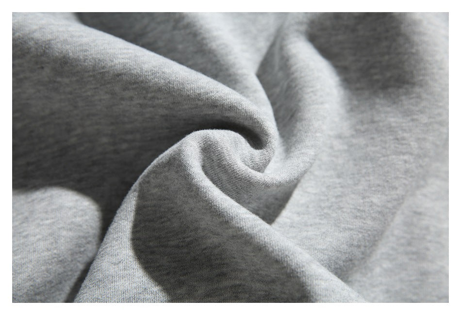 Close-up showing the soft-looking heather gray knit fabric gathered into folds.