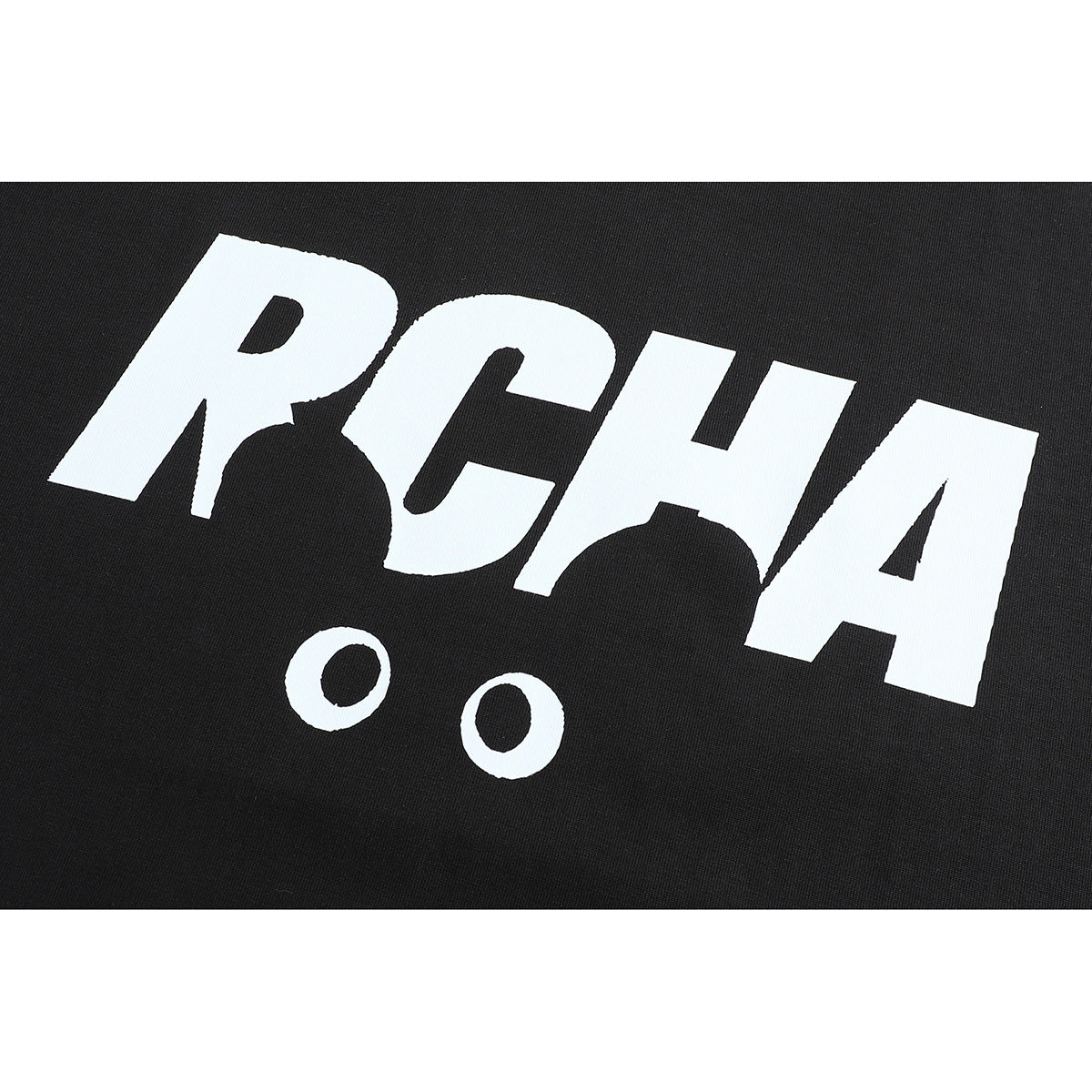Close-up of a bold white stylized letter graphic printed on black T-shirt fabric.