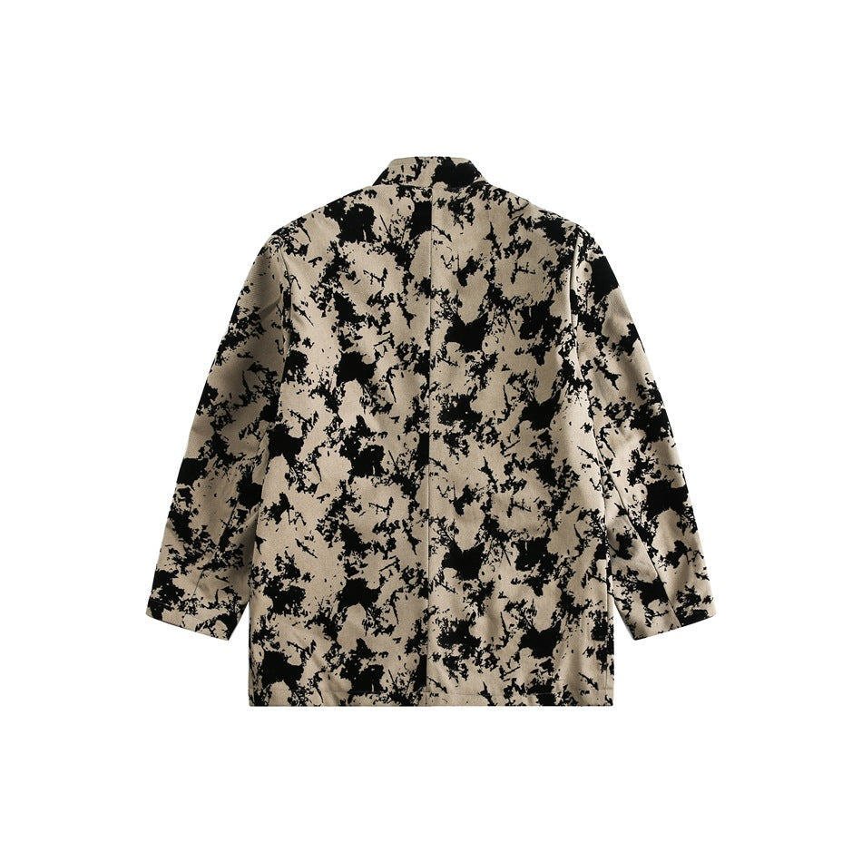 Rear view of a beige jacket with an irregular black pattern, long sleeves, and a short stand collar.