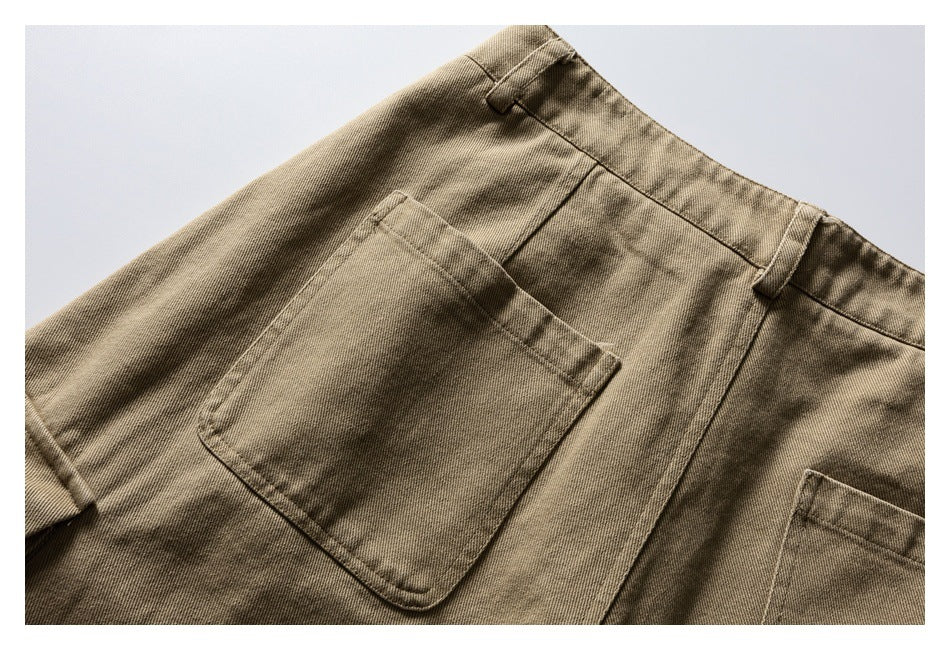 Close-up of a tan trouser back pocket, waistband, belt loops, and stitching.