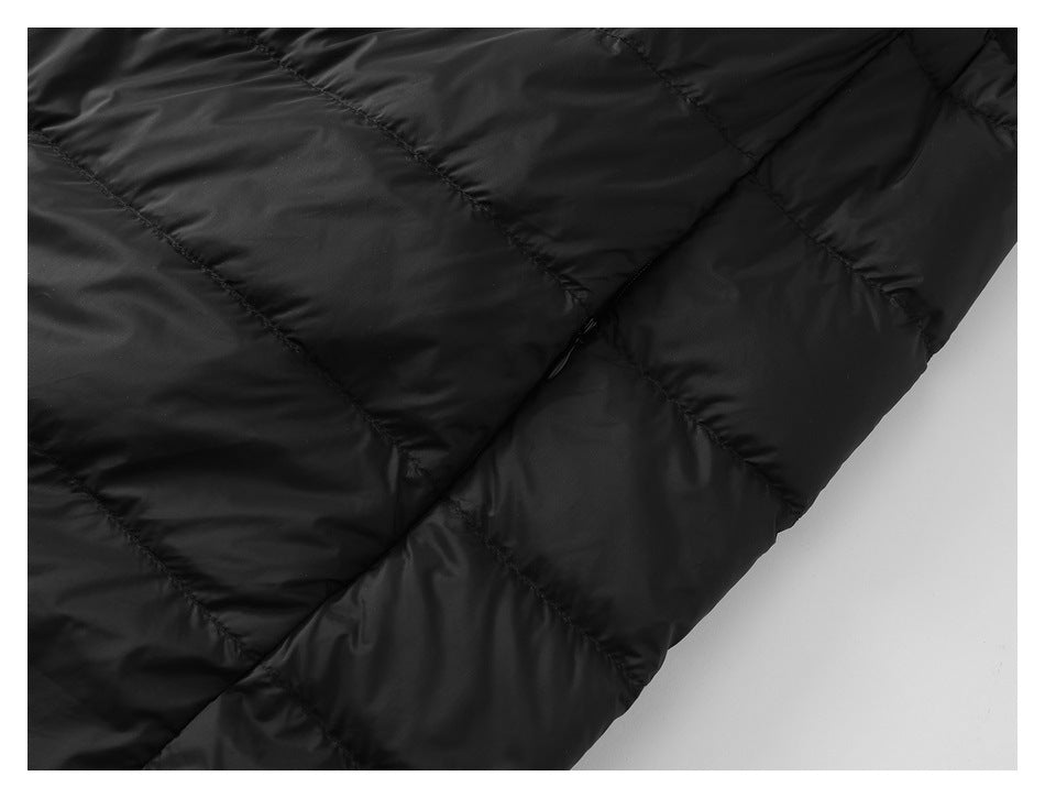 Close-up of black quilted vest fabric, showing diagonal seams and a side seam.