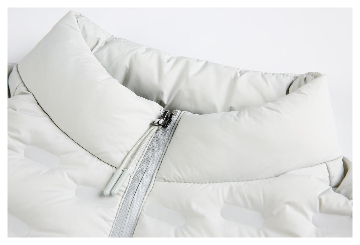 Close-up of a white padded jacket showing the collar and gray front zipper with two pull cords.