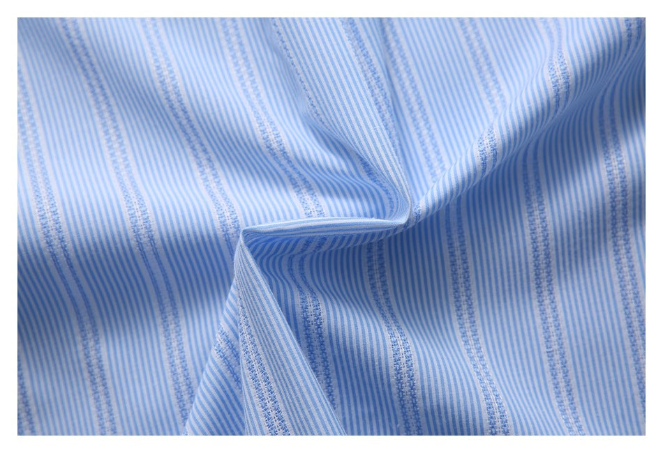 Close-up of blue-and-white striped fabric with narrow textured vertical bands, draped into folds.