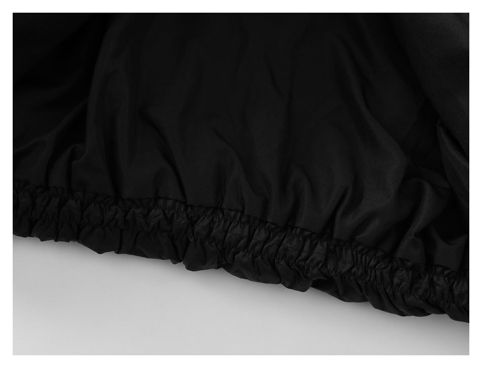 Close-up of the black jacket's gathered elastic hem.