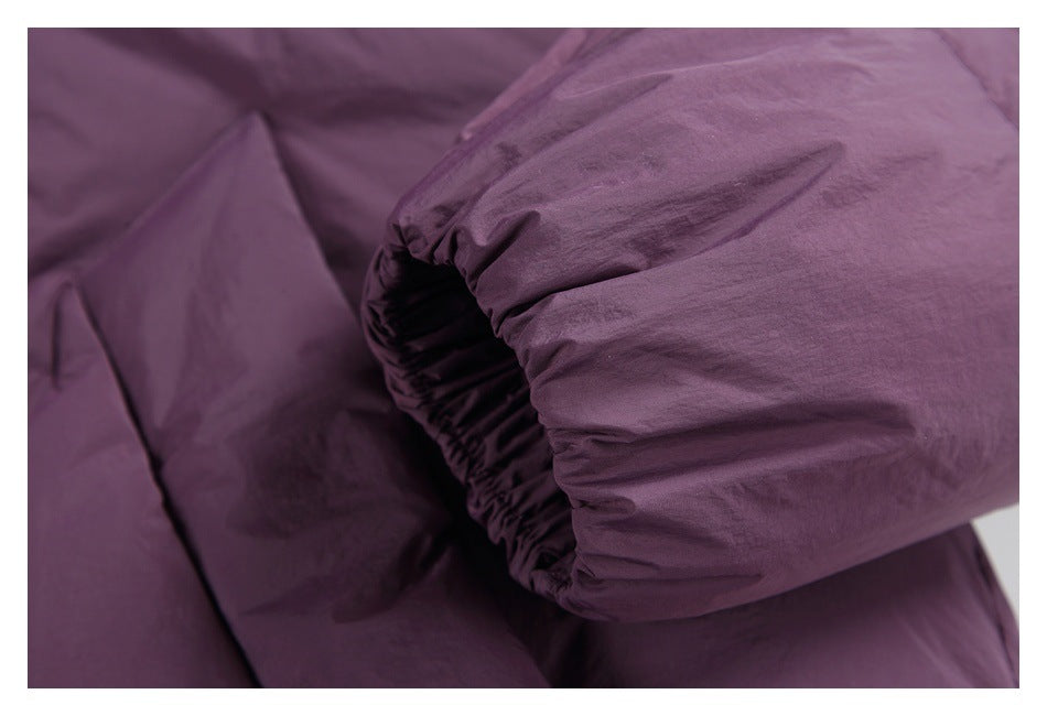 Close-up of a plum-purple padded jacket sleeve with a gathered elastic cuff.
