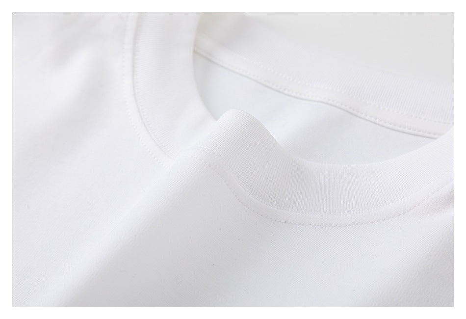 Close-up of the white shirt's ribbed crew neckline and stitching.