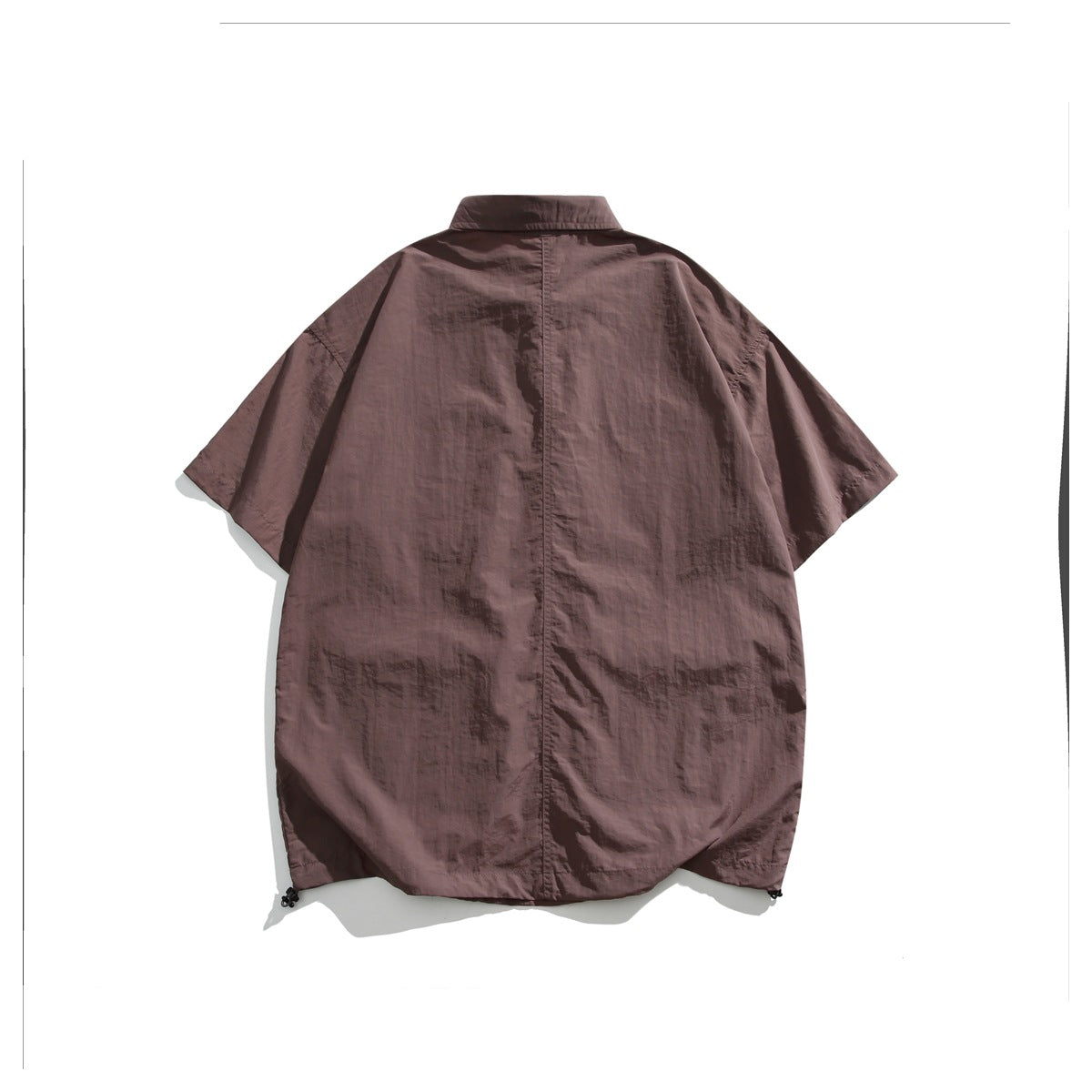 Back view of a mauve short-sleeve collared shirt with a center seam and drawcords at the hem.