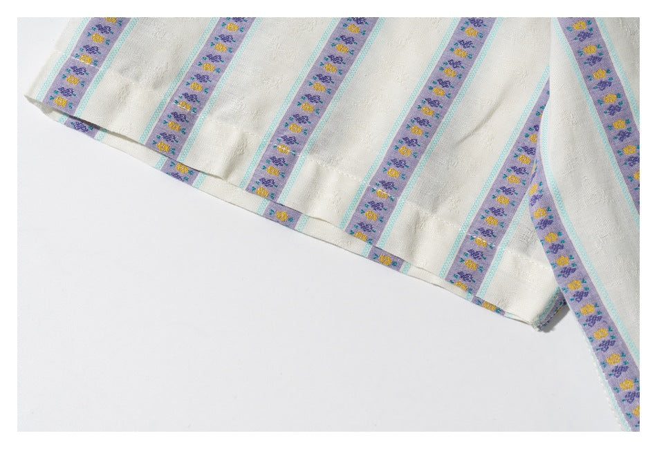 Close-up of the ivory shirt’s hem, showing lavender floral stripes with turquoise borders.