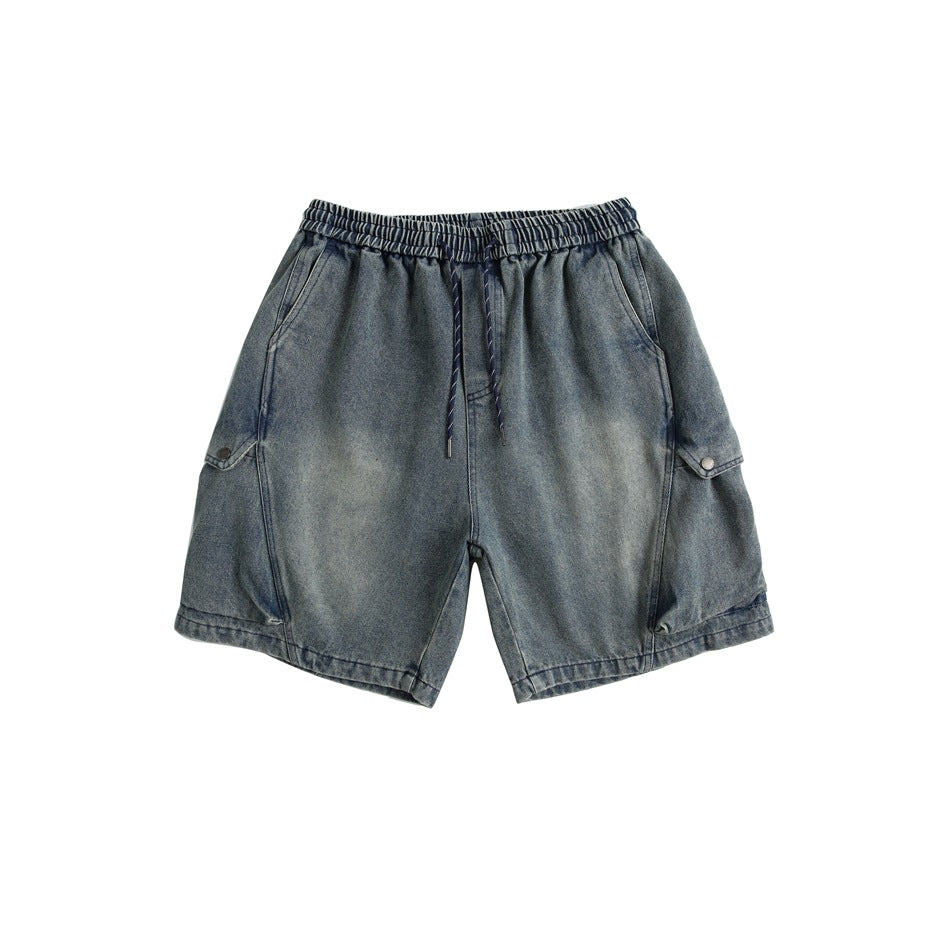 Front view of faded blue denim shorts with elastic drawstring waist and side cargo flap pockets