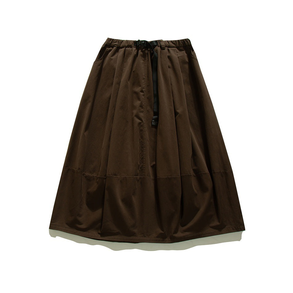 Dark brown A-line midi skirt with elastic waist, black buckle belt and paneled hem, flat lay