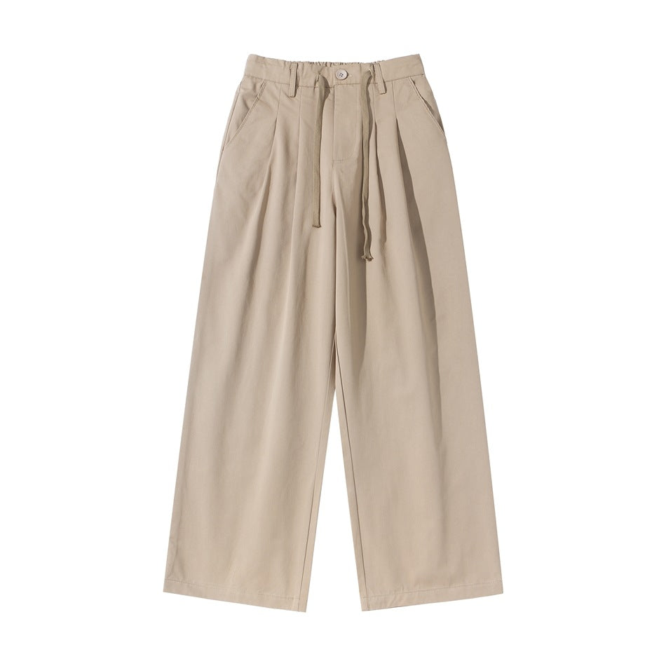 Light khaki wide-leg pleated pants with elastic waistband, drawstring and slant pockets, flat lay front view