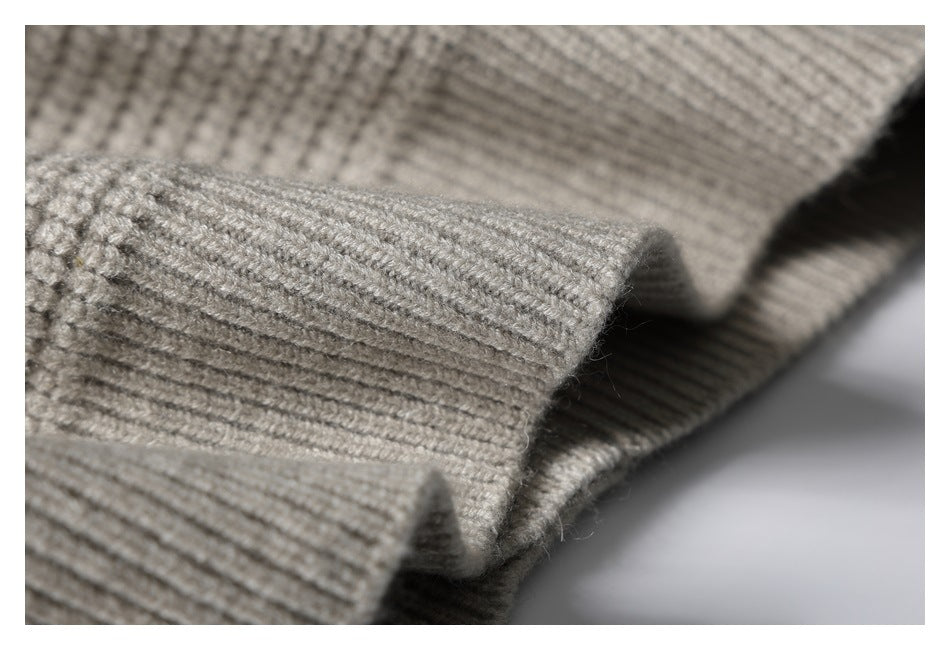 Close-up of a folded taupe-gray knit edge with prominent parallel ribbing.