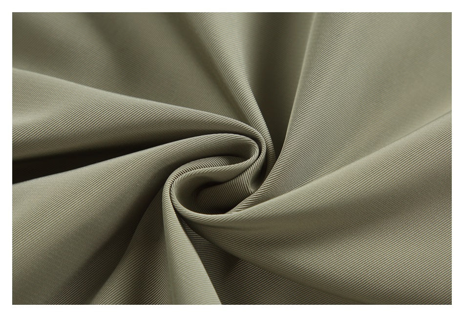 Close-up of olive-gray woven fabric gathered into a spiral fold.