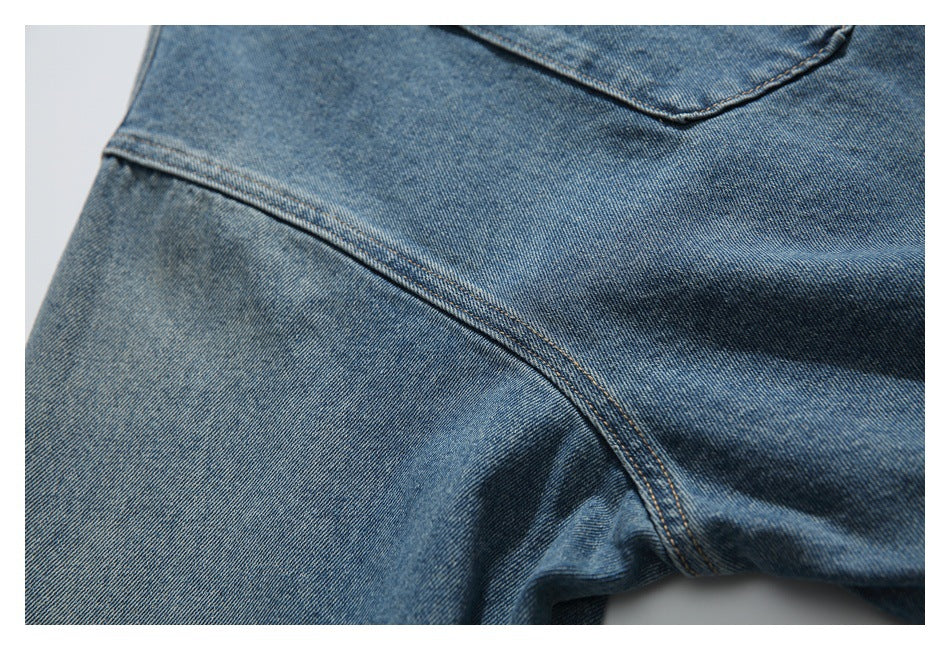 Close-up of blue denim fabric and curved double-stitched seams.
