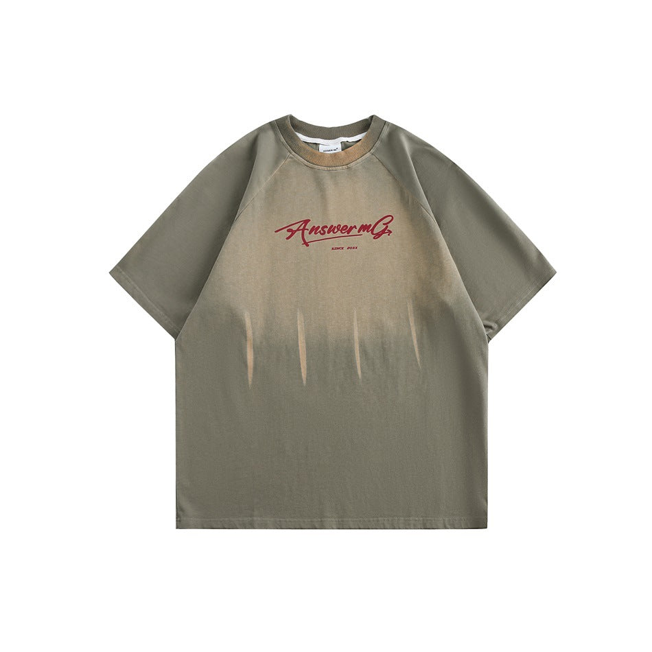 Olive green short-sleeve raglan T-shirt with faded gradient wash, claw streaks and red script chest graphic