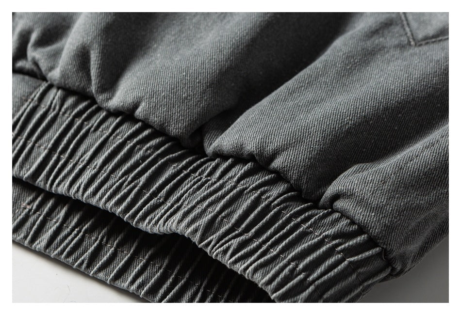 Close-up of a gathered elastic waistband on a dark gray garment.
