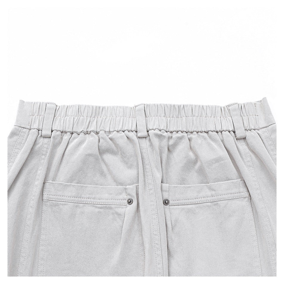 Close-up of the light gray trousers' elasticized back waistband, belt loops, and two rear pockets.