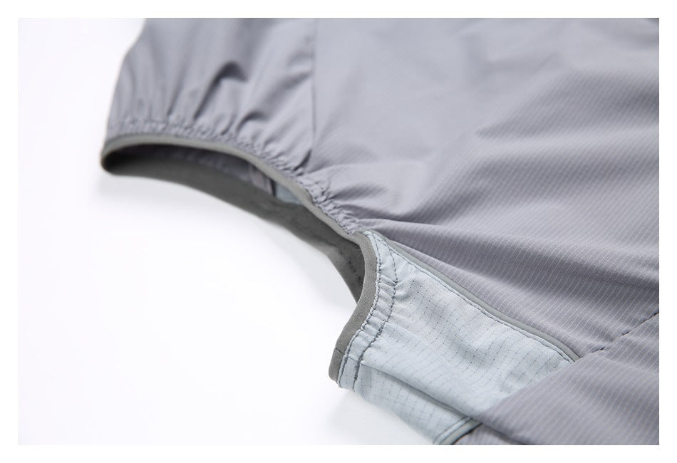 Close-up of a gray garment seam with gathered stitching and a pale inner panel.