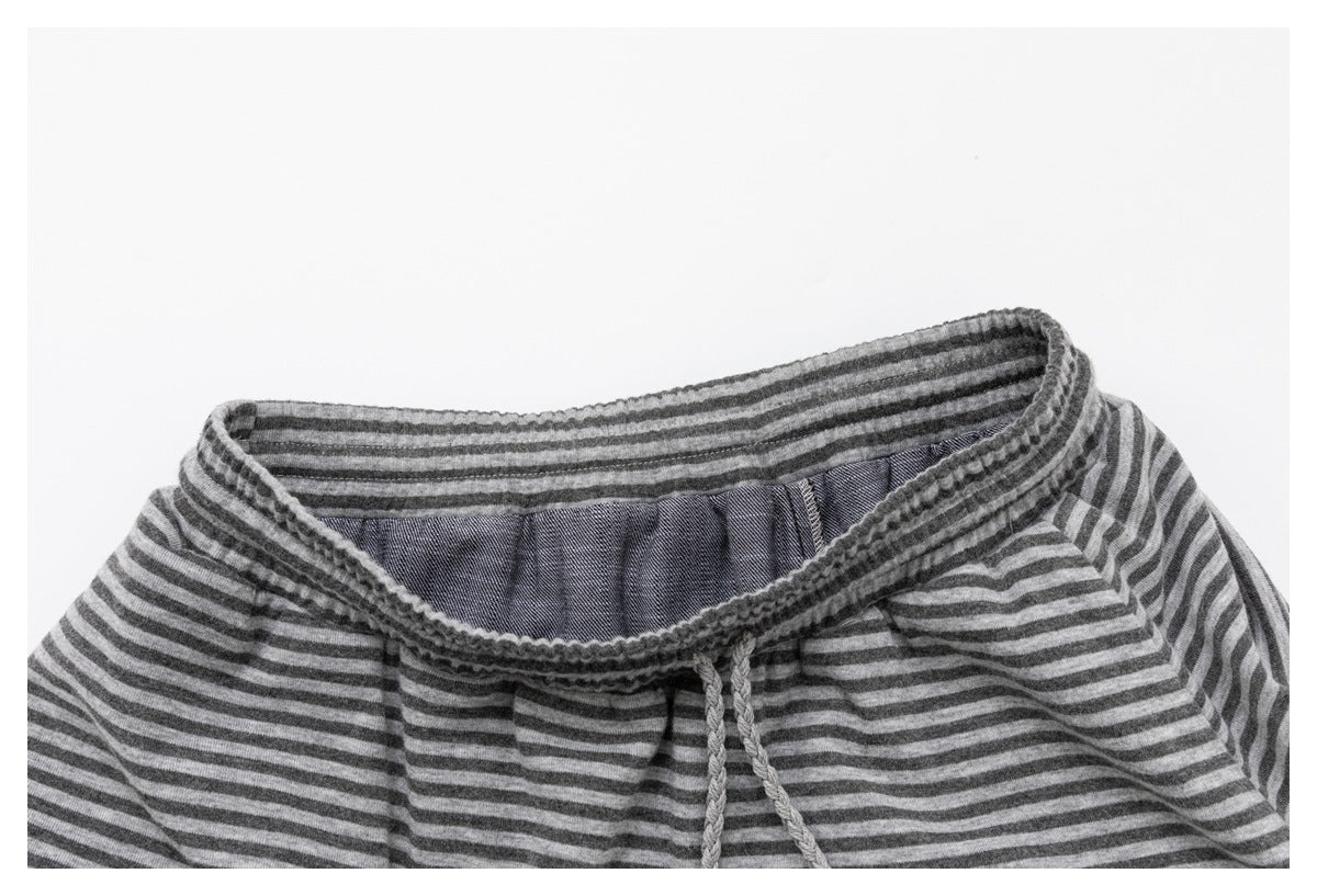 Close-up of the gray striped garment's elastic waistband and inner facing.