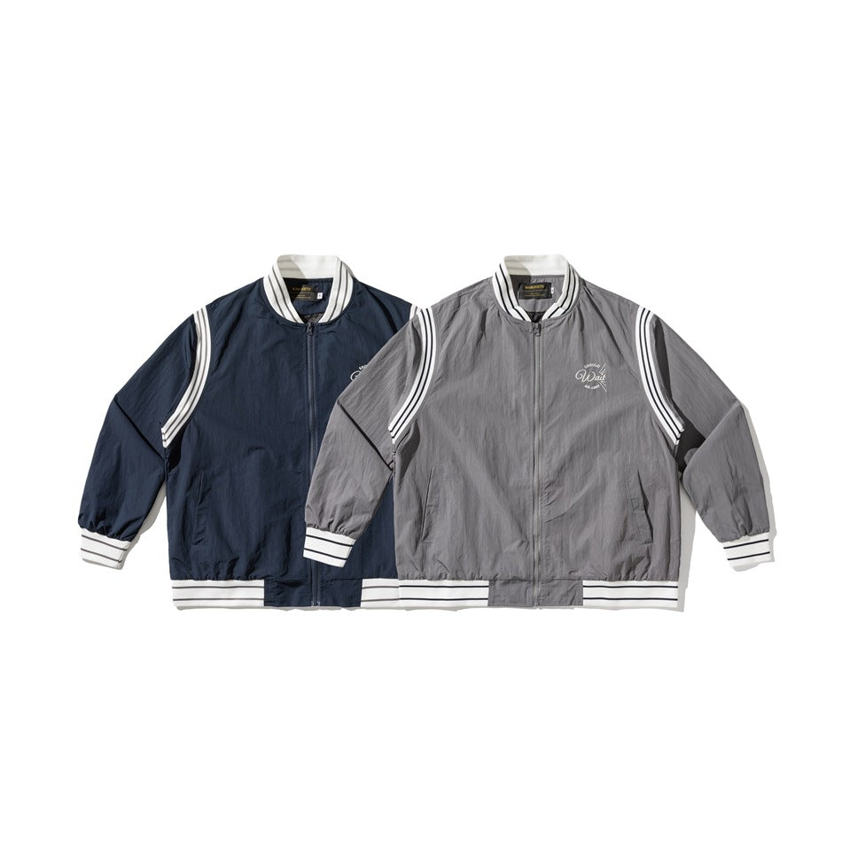 Two zip jackets shown front-facing in navy and gray, both with white striped trim.