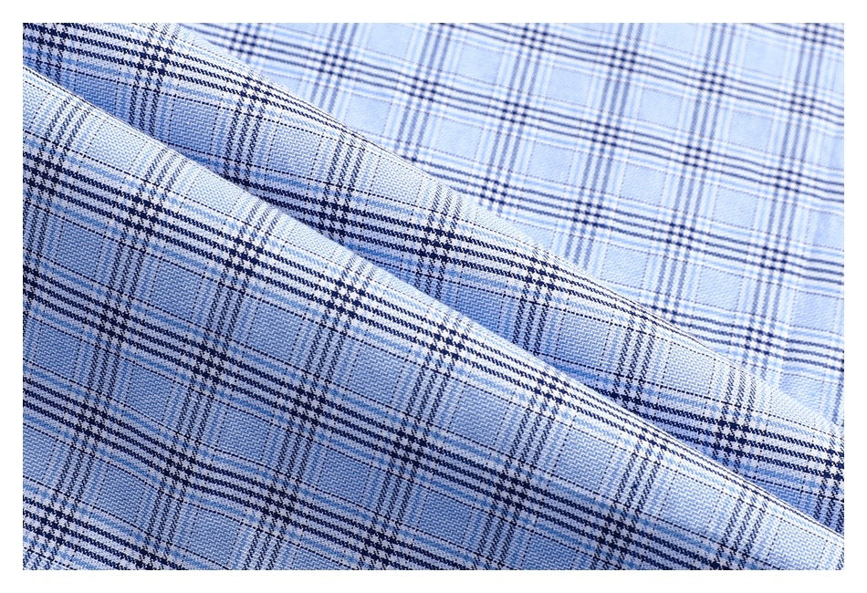 Close-up of the light blue and navy plaid pattern on the shirt fabric.