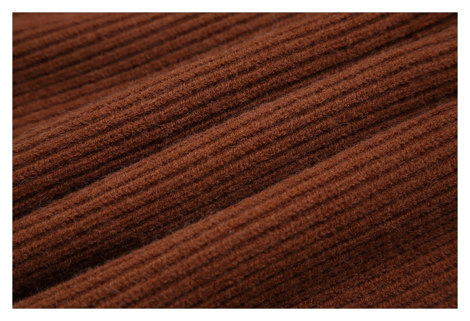 Macro view of the raised ribbed knit texture in rust brown.