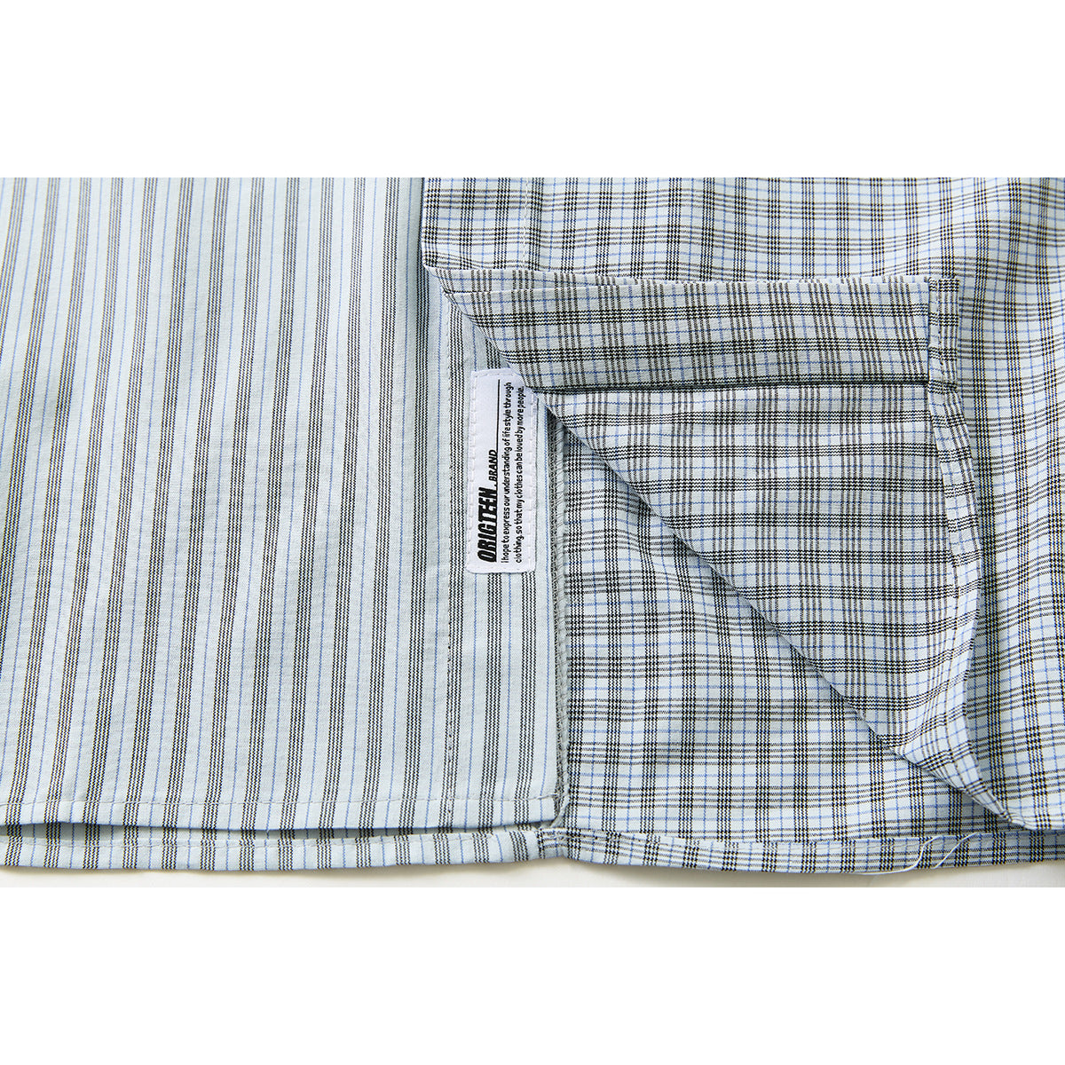 Close-up of a shirt's striped and checked panels with an inside label and stitched seam.