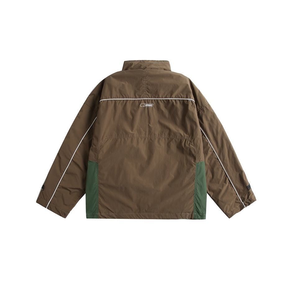 Back view of a brown jacket with dark green lower side panels and white piping, shown flat on white.