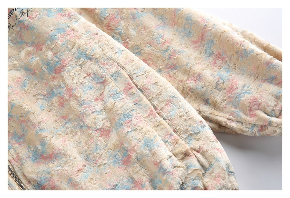Close-up of the jacket's patterned sleeve and body seam, with a partial zipper at the edge.