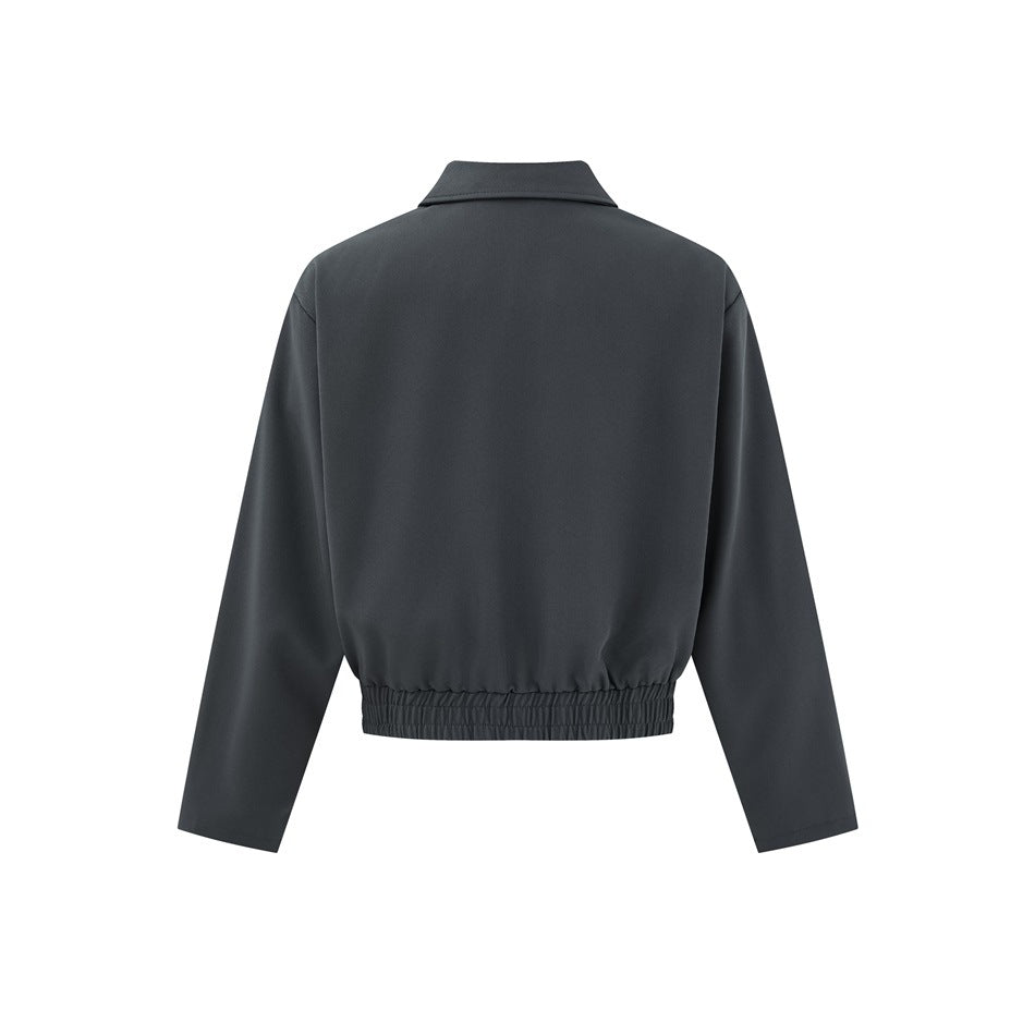 Back view of a charcoal cropped jacket with long sleeves and a gathered elastic hem.