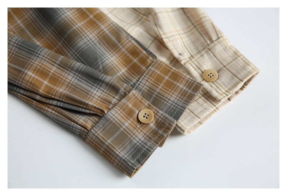 Close-up of beige and brown plaid shirt sleeves with buttoned cuffs.
