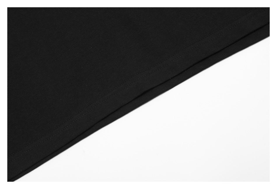 Close-up of the stitched bottom hem on a black T-shirt.