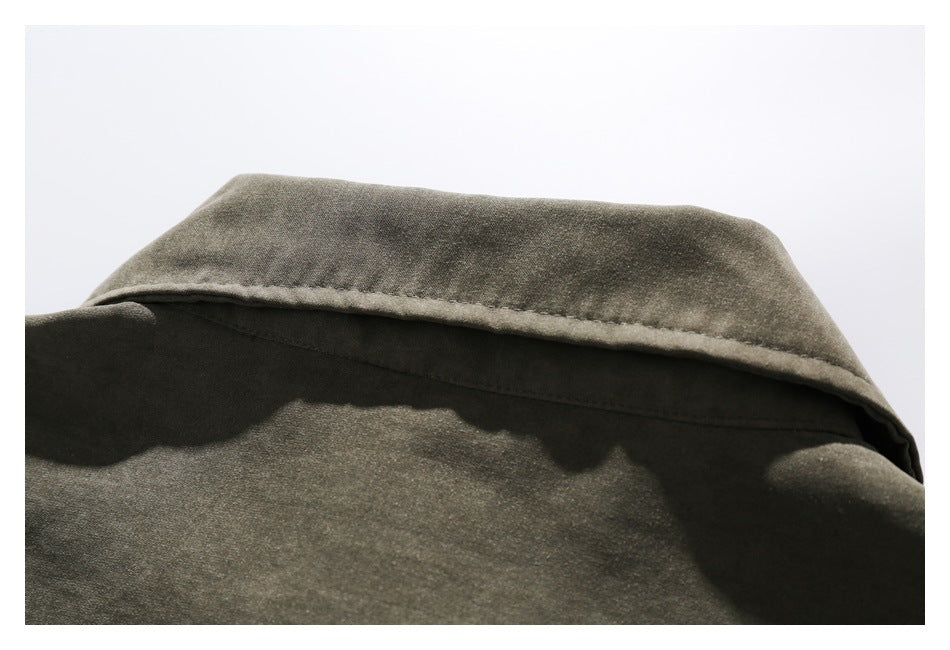 Close-up of the back of an olive shirt collar and its stitching.