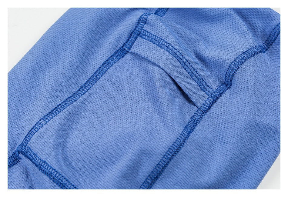 Close-up of blue garment panels with a small opening and dark stitched seams.