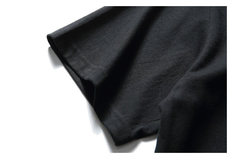 Close-up of the black T-shirt sleeve and stitched cuff against a white background.