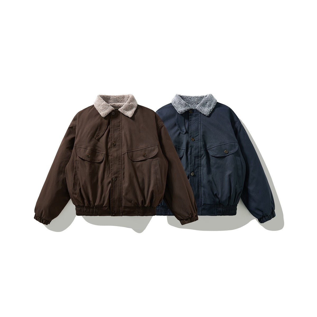 Front views of two jackets, one dark brown and one navy, with fuzzy collars and elastic cuffs and hems.